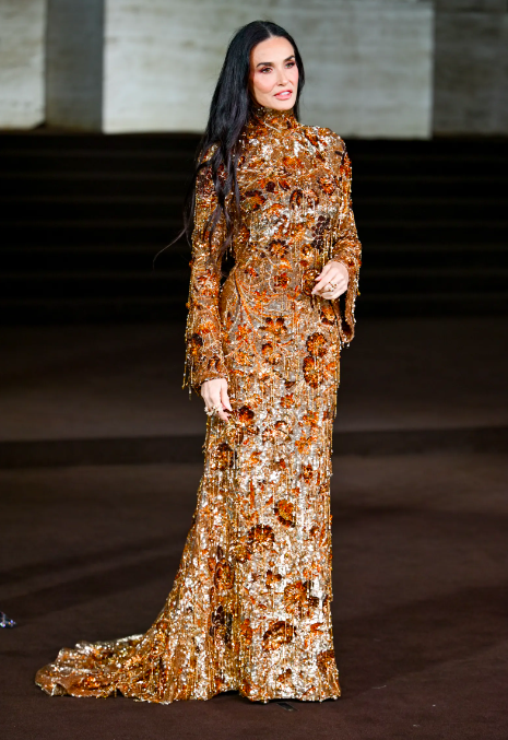 Demi Moore Dazzles in Gold Gucci Gown at Milan Fashion Week